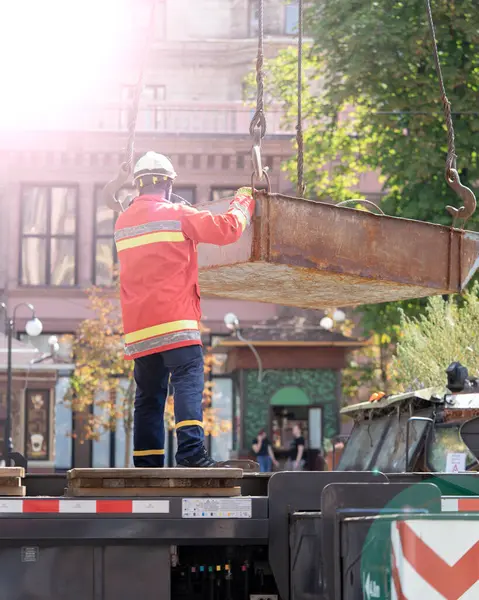 Unloading cargo and loading cargo with a crane. Crane boom and hook against the sky with engineering details and knots.