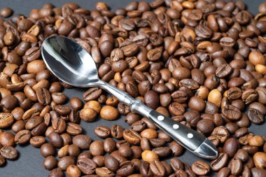 Top view of roasted coffee beans for background and texture. A pile of roasted and ground coffee beans can be used as a background and texture.