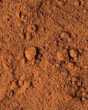 Top view of roasted coffee beans for background and texture. A pile of roasted and ground coffee beans can be used as a background and texture.