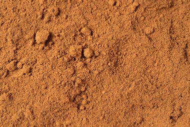 Top view of roasted coffee beans for background and texture. A pile of roasted and ground coffee beans can be used as a background and texture.