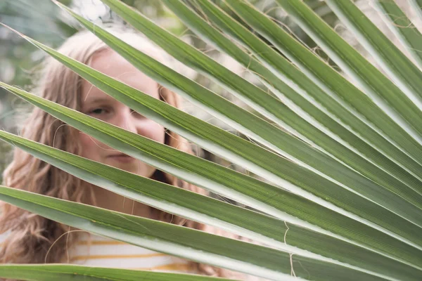 Blond Curly Teenager Girl Hiding Large Palm Leaf Sea Vacation — Stock Photo, Image