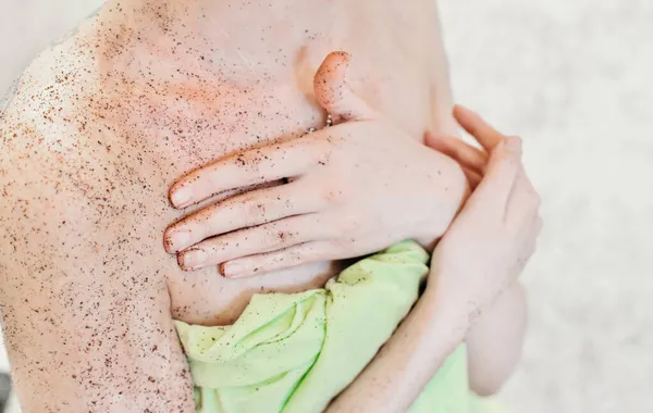 woman applying body exfoliating scrub. natural organic coffee polish on a womans body.