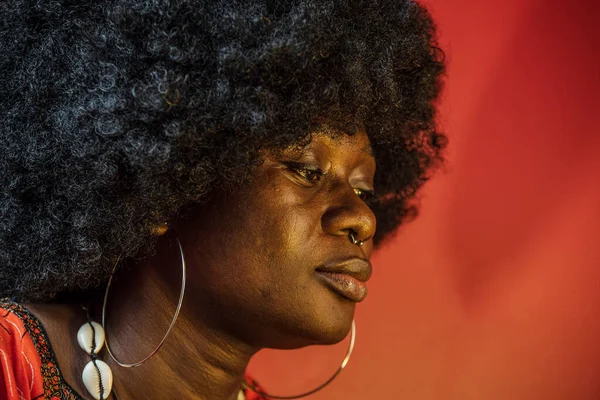 African woman face inside with orange light and traditional African hair