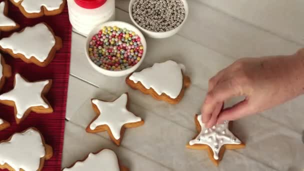 Zeitraffer Von Geformten Weihnachtsplätzchen Die Mit Zuckerperlen Verziert Werden — Stockvideo