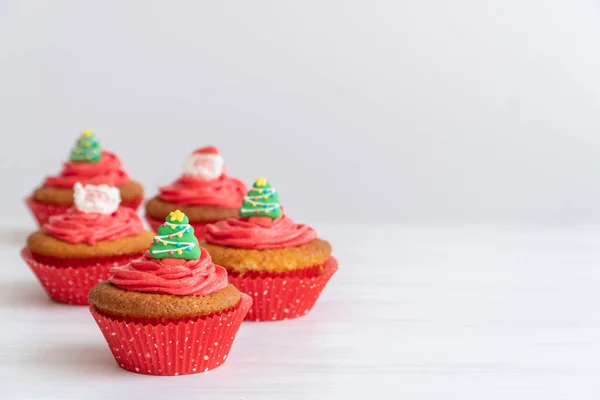 Red Christmas Cupcakes Tree Santa Toppers White Background Copy Space Imagen de archivo