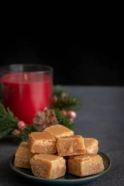 Butterscotch Fudge Plate Christmas Candle Dark Background Copy Space Vertical — Stock Fotó