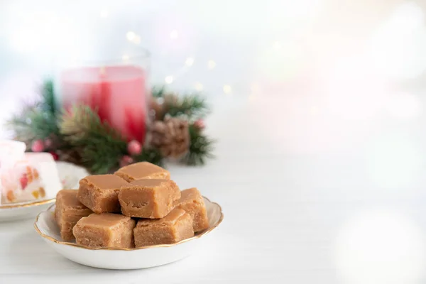 Caramel Fudge Plate Christmas Candle Lights Light Background Copy Space — Stock Fotó