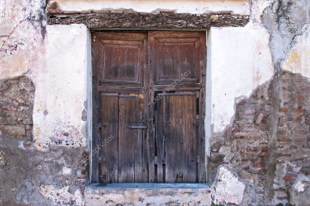 Old wooden door with exposed wall