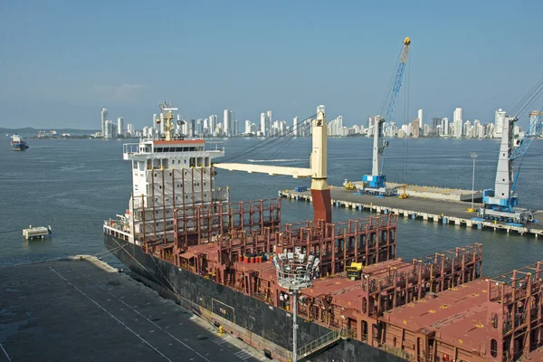 Docked freighter with city in background — Stock Photo, Image