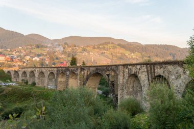 Dağlardaki büyük, eski bir su kemeri köprüsü.