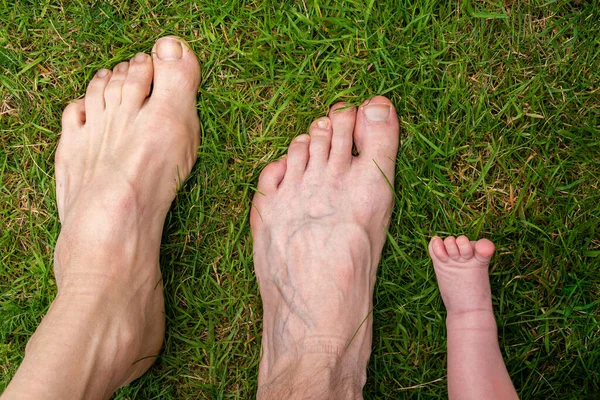 Males feet, three different generations, old, adult and newborn, family together