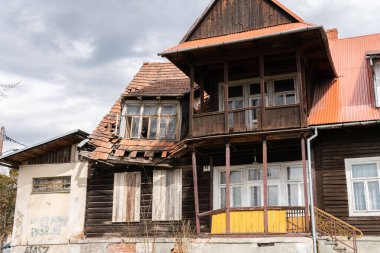An old wooden burnt and worn out house with broken roof 