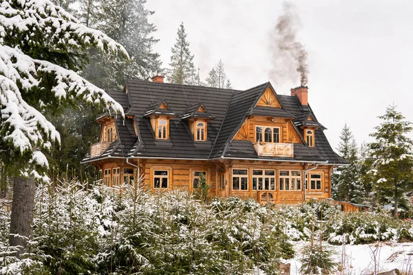 A beautiful big old ancient wooden house with chimney