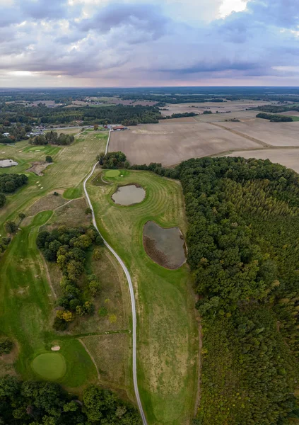 Beautiful aerial vertical panorama of a golf field, stormy weather, rural landscape