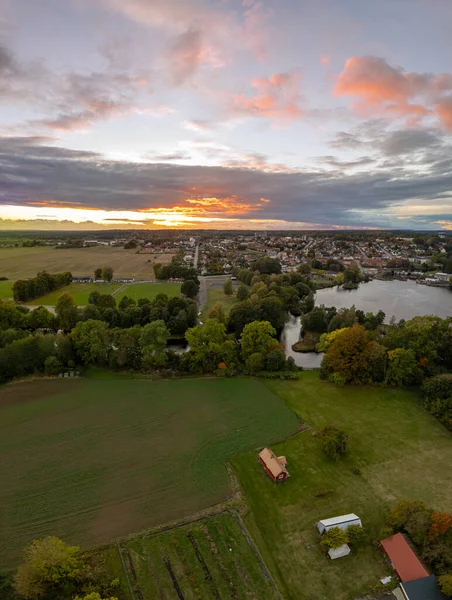 Beautiful aerial vertical panorama of a little village in Sweden, stormy weather and sunset, rural landscape