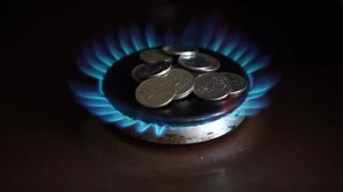 Russian ruble coins on the gas stove burner. Russian ruble on burning gas. The concept of the price for Russian gas in Europe. Payment for gas in Russian rubles