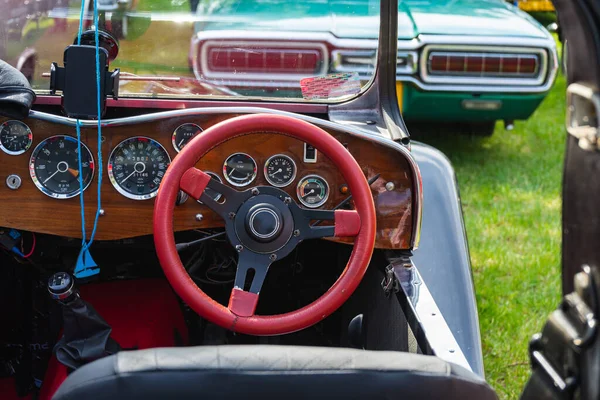 retro car dashboard interior. View of the steering wheel and dashboard of an old vintag car