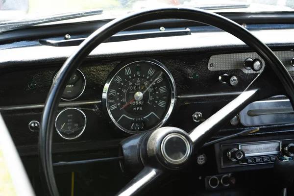 retro car dashboard interior. View of the steering wheel and dashboard of an old vintag car.