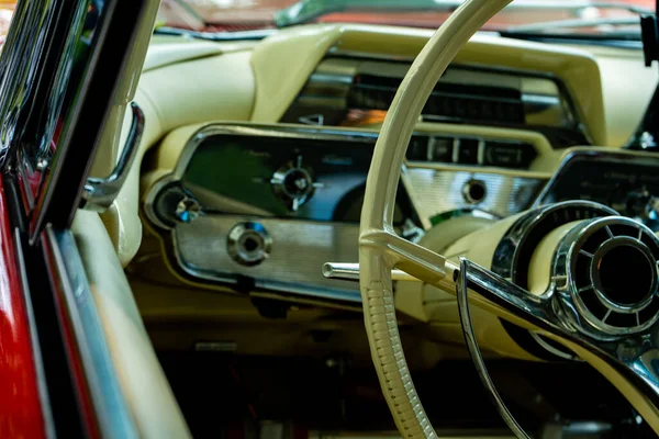 retro car dashboard interior. View of the steering wheel and dashboard of an old vintag car.