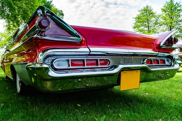 Old retro car in bright red color, rear view.