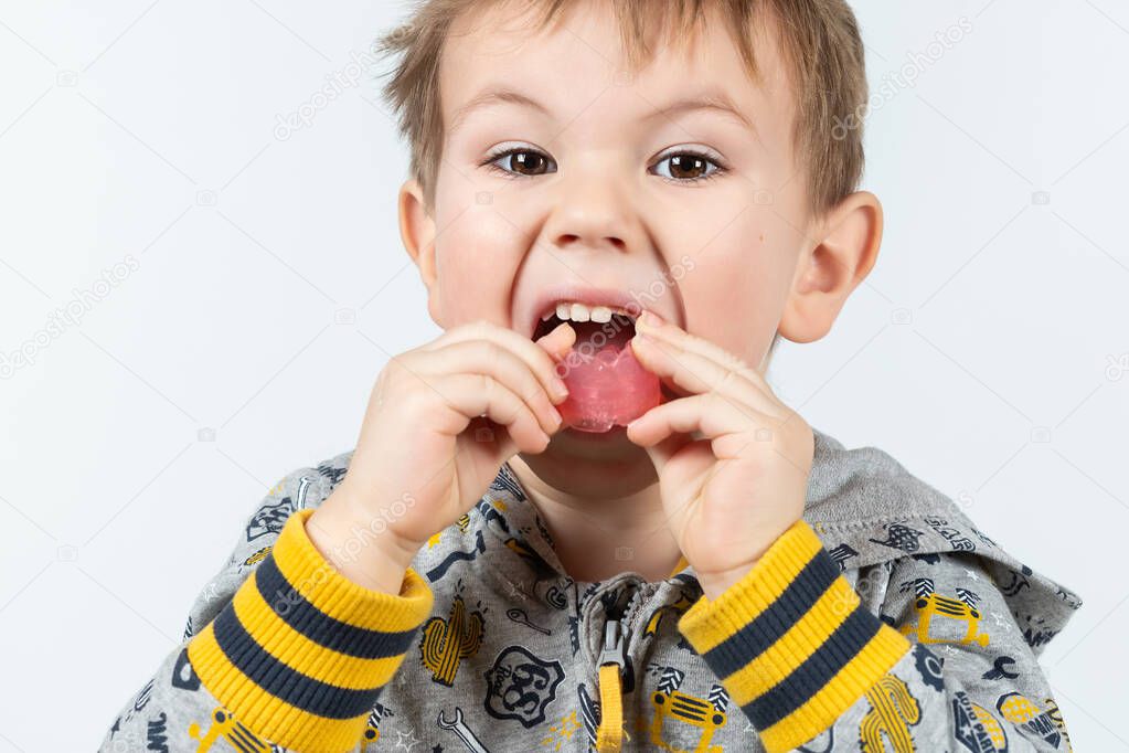 Adorable little child puts myofunctional trainer in the mouth. dental tariner is made to help equalize the growing teeth and correct bite and Correct the position of the tongue