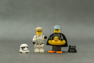 Bauru, Brezilya. 15 Eylül 2019. Star Wars lego figürü. Darth Vader ve dişi Stormtrooper kasksız, güneş gözlüklü ve tatilde. Darth Vader eğlence için sarı ördek şamandırası kullanıyor..