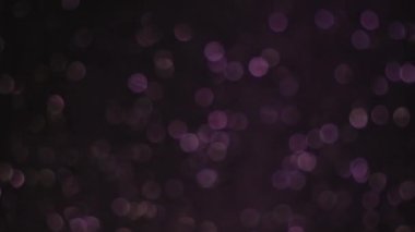 Koyu arkaplanda yanıp sönen bokeh dairelerin döndürülmesi