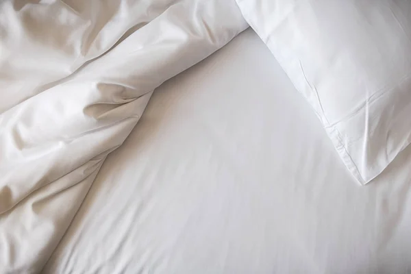 White bedding sheets and pillow in bedroom. Morning lifestyle concept.