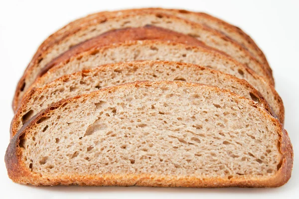 Skivat bröd på vit bakgrund Stockbild