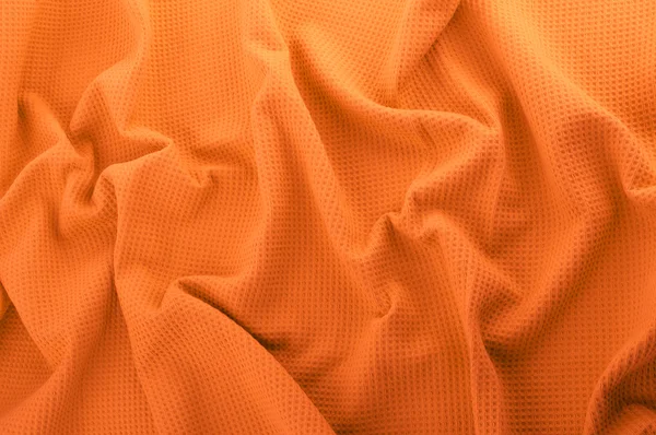 Апельсиновая ткань в качестве фона — стоковое фото
