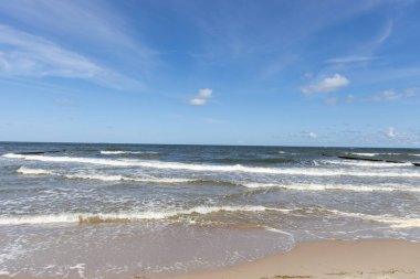 High and dangerous waves on the beach of Zempin on the island of Usedom on a beautiful day in summer