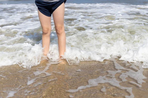 Boy Stands Sandy Beach Enjoys Waves His Legs — Stock Photo, Image