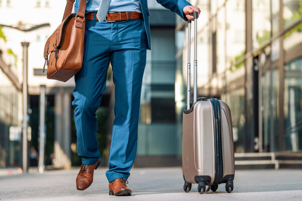 Young businessman with suitcase travelling.Businessman with luggage in airport.