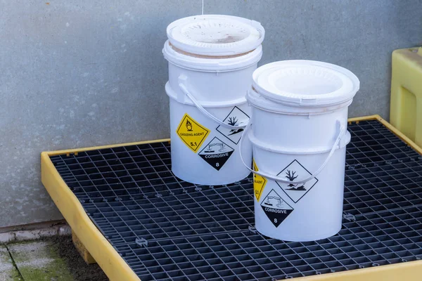 Tehlikeli ürün etiketli kaplar tedavi ve geri dönüşüm için özel bir yerde saklanır.