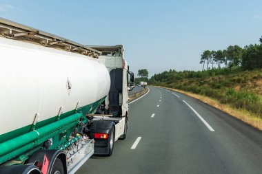 Fuel tanker truck driving on a highway.
