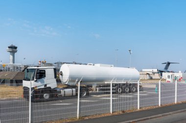 Aviation fuel tanker unloading at an airport facility.