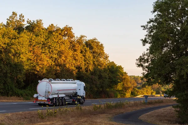 Fuel tanker truck driving along a conventional highway.