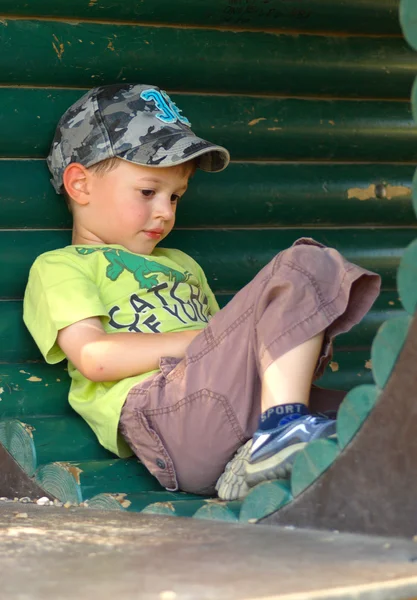 Little boy thinking in a wood pipe — Stock Photo, Image