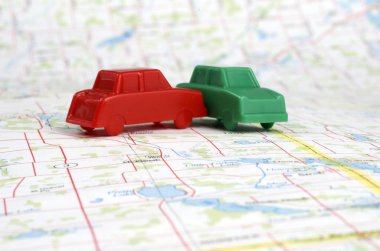 Miniature Plastic Cars On Map clipart