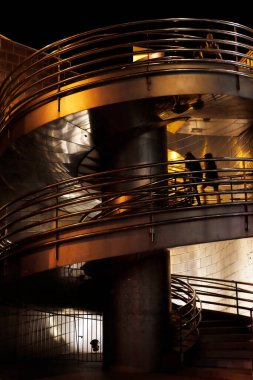 Geceleri şehir ortamında yürüyen insanlar.