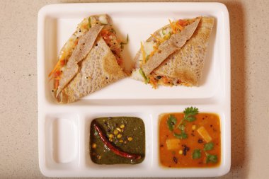 Ragi Dosa is a fermented crepe or pancake made from Ragi batter  clipart