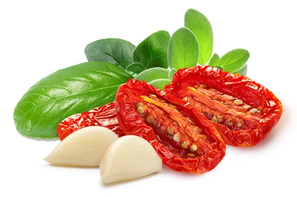用香草和大蒜分离的晒干或晒干的西红柿片 图库图片