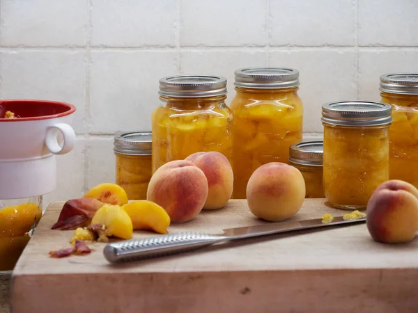 Late  summer, autumn, DIY home organic peach canning, preserving, the peach harvest on a wooden cutting board