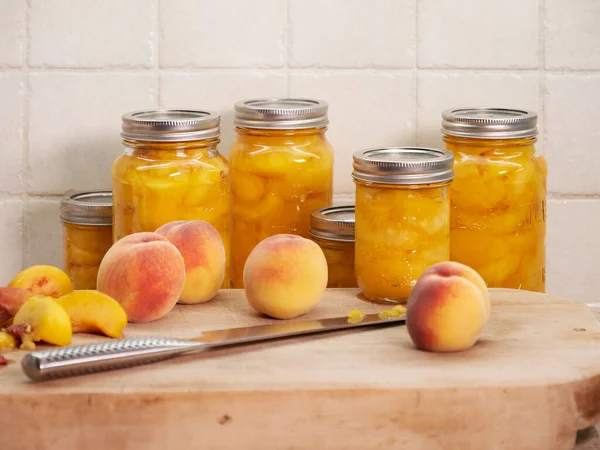 Late  summer, autumn, DIY home organic peach canning, preserving, the peach harvest on a wooden cutting board