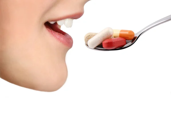 Medical tablets from a spoon — Stock Photo, Image