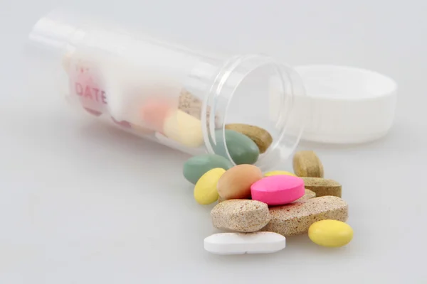 Pills spilling out of bottle — Stock Photo, Image