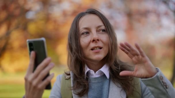 Una turista femenina haciendo un autorretrato, una turista europea adulta por videoconferencia, aplicación de chat, comunicación remota, un turista con teléfono, camping y redes sociales — Vídeo de stock