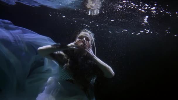 Underwater fairy is floating in depth, magical and mysterious female figure in dark water — Stockvideo