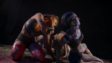 choreographic sketch, modern dance performance with paints, four young women are dancing together