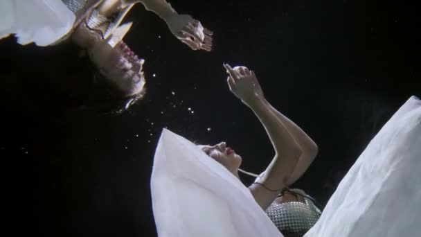 Amazing underwater shot of pretty lady floating under water surface, magic reflection — Stock video